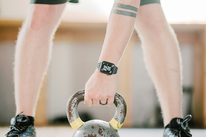 Man lifting kettlebell closeup at Sports Center Performance Zone